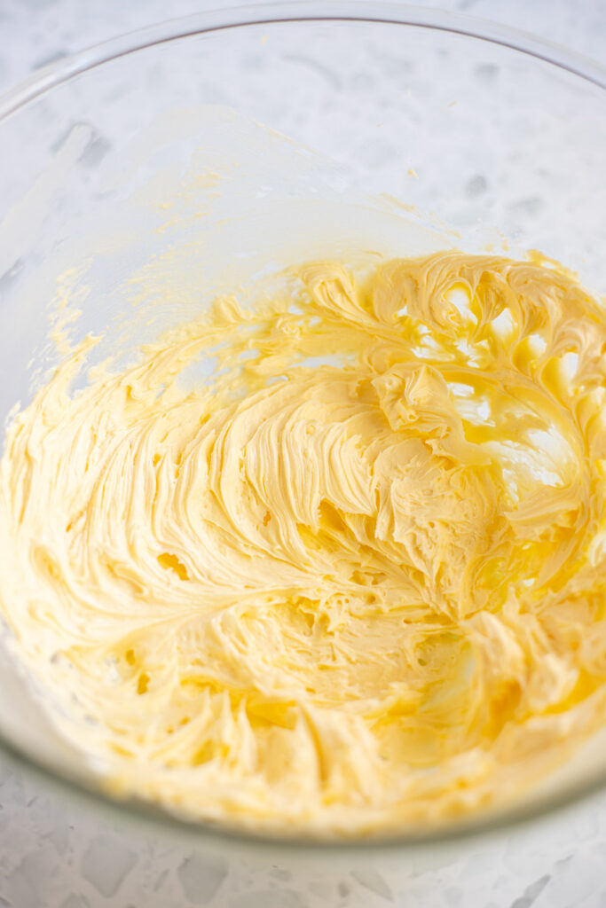 Glass bowl with creamed butter and icing sugar for making shortbread dough.