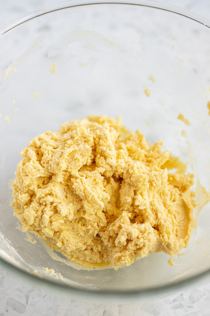 Lemon shortbread dough in a mixing bowl, ready for rolling out.