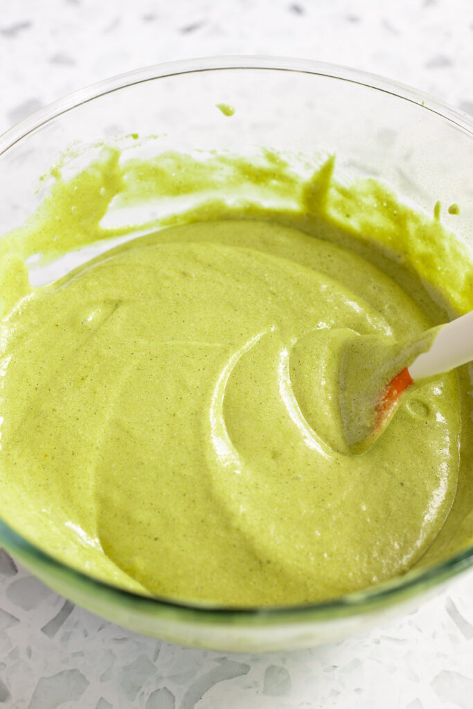 Light and foamy matcha cake batter ready for baking, with egg whites fully incorporated.
