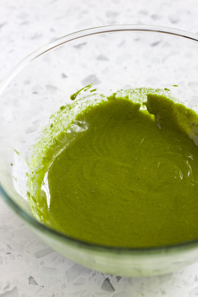 Bowl of matcha cake batter, ready for beaten egg whites to be folded in.