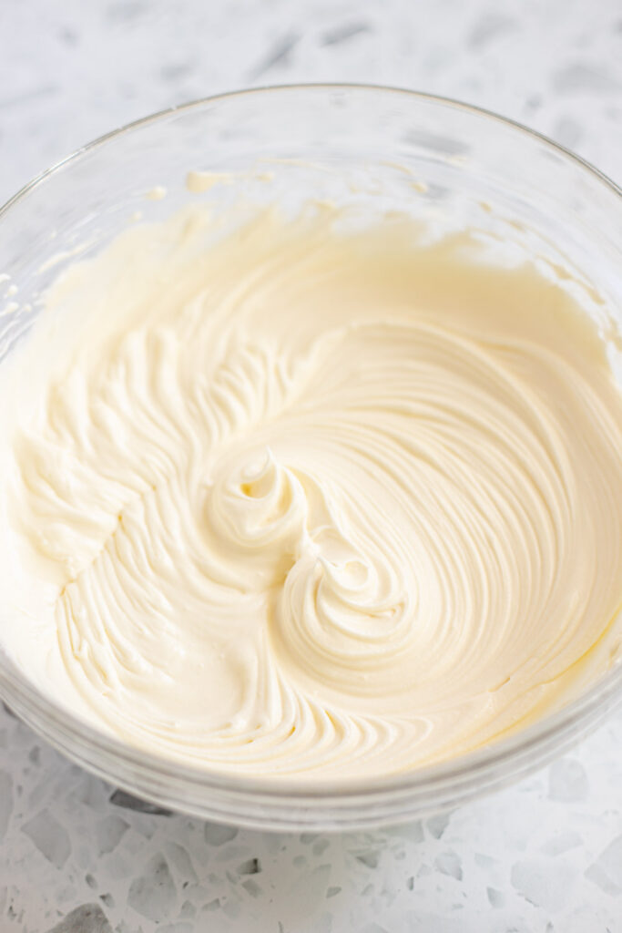 Bowl of stabilised whipped Chantilly cream beaten to stiff peaks.