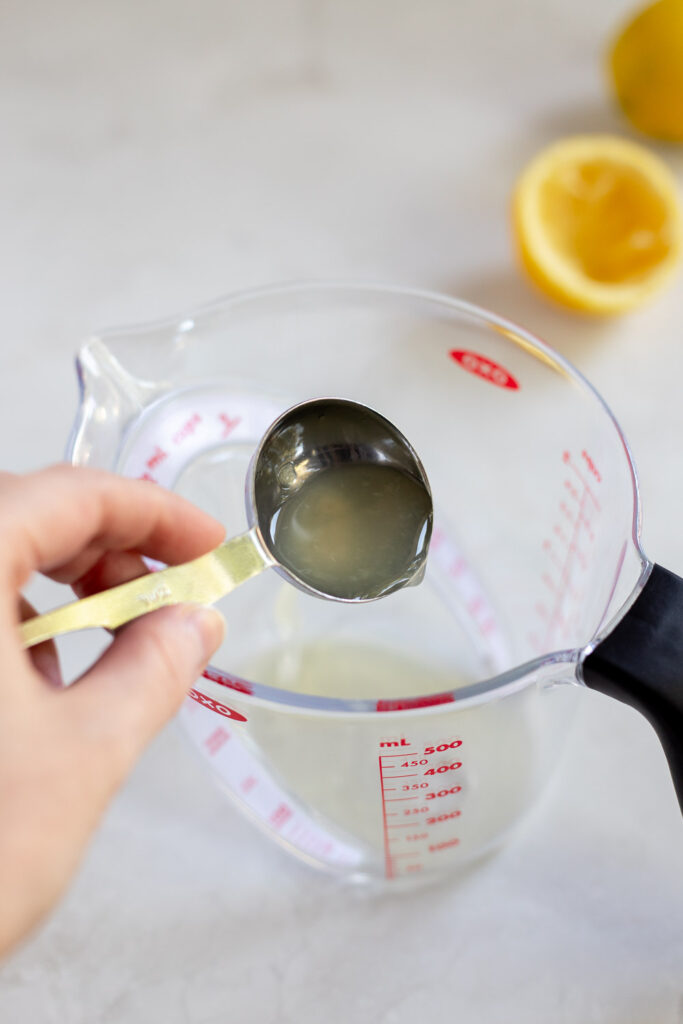 Lemon juice being added to a measuring jug