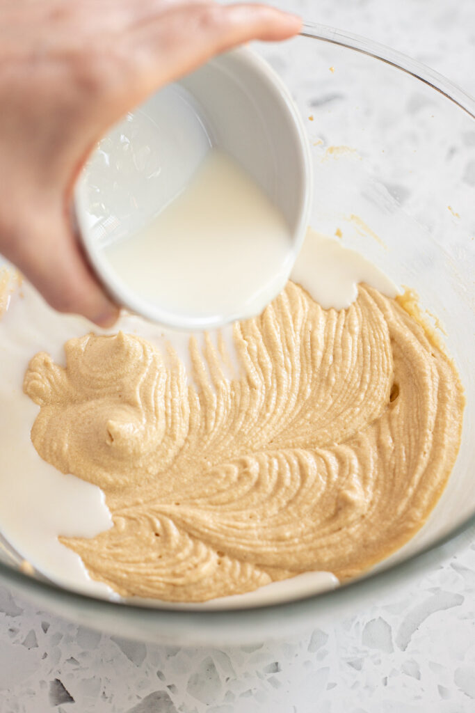 Pouring milk into cake batter