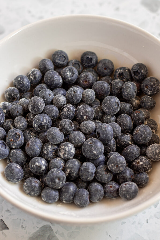 Bowl of fresh blueberries dusted lightly with flour to prevent sinking