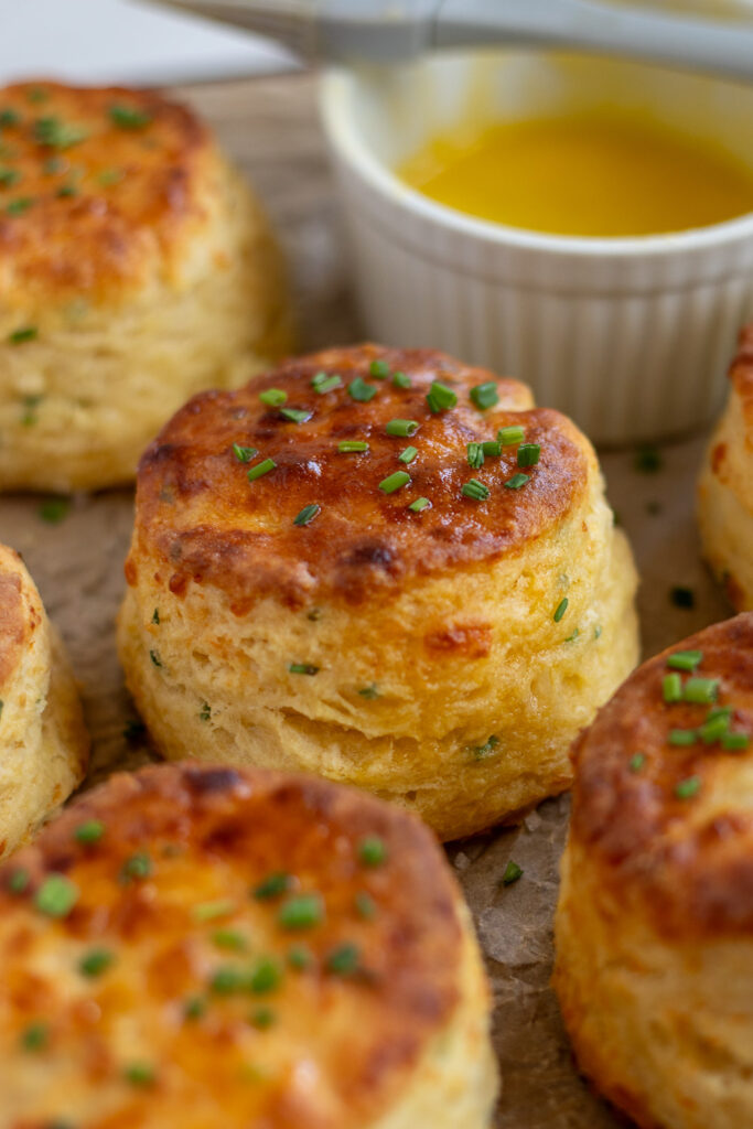 Close-up of cheddar chive buttermilk biscuits, highlighting a recipe that can be made with a buttermilk substitute