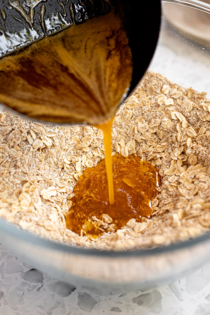 Pouring hot butter and golden syrup mixture into dry ingredients