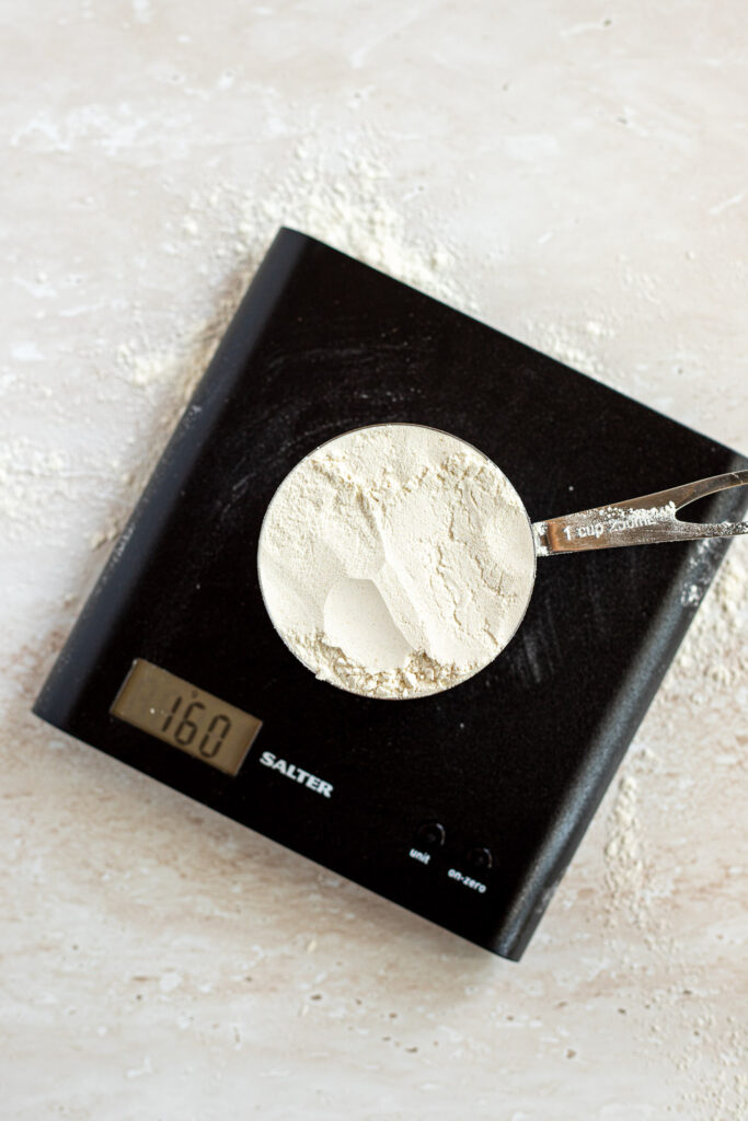 250ml measuring cup of flour scooped directly from the bag, compacted and weighing 160 grams on a kitchen scale.