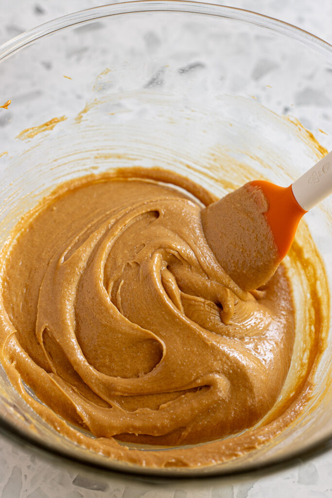 Smooth, light brown cookie dough mixture after beating wet ingredients until combined