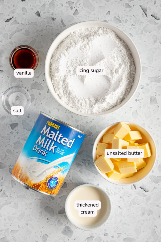 Labelled flatlay of vanilla malt buttercream ingredients, including a tin of Nestlé malted milk drink powder
