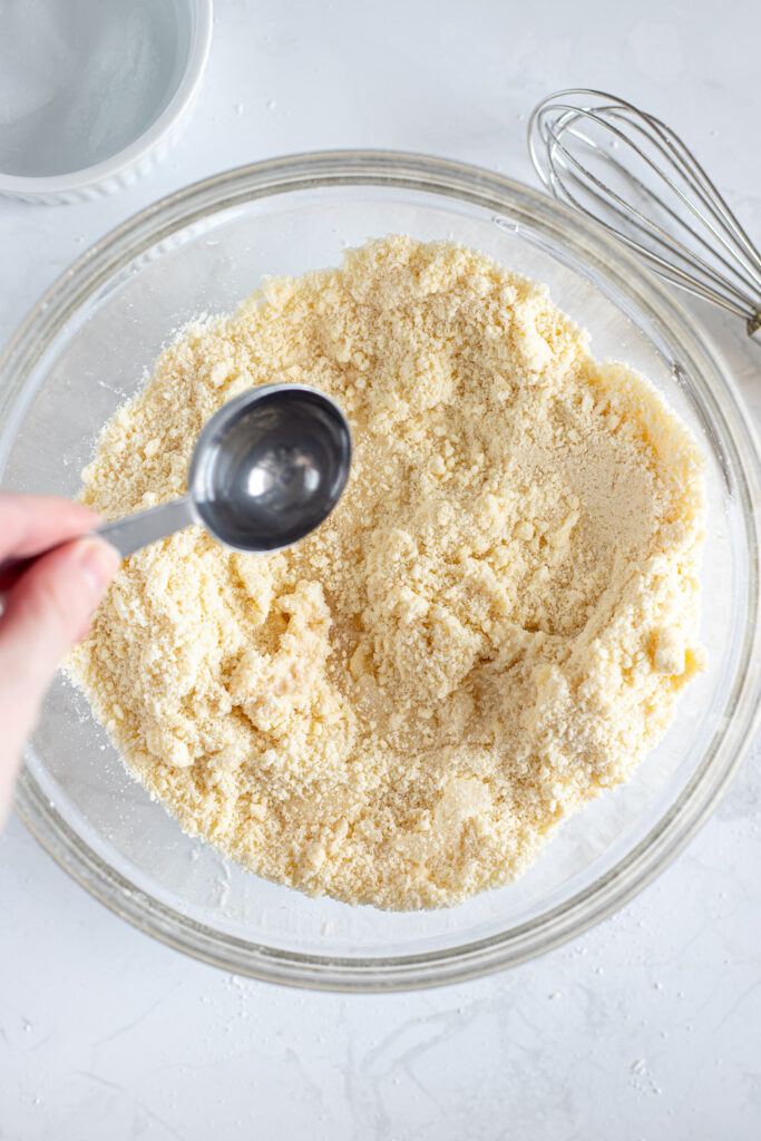 Adding ice water to butter and flour mixture, one tbsp at a time.