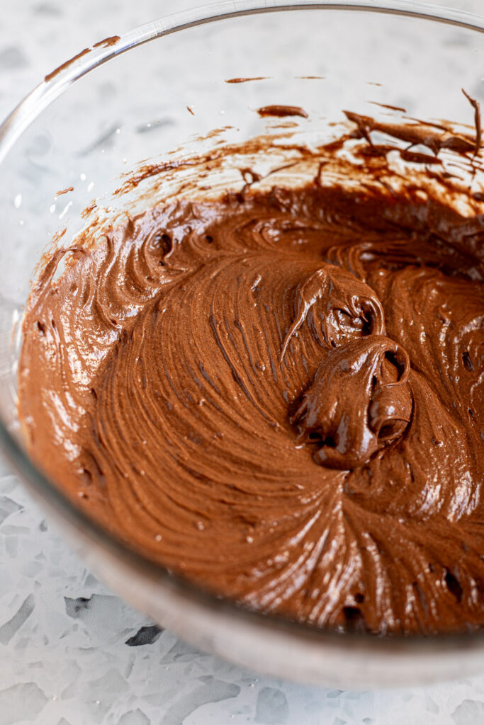Thick chocolate brownie batter ready for the addition of almond meal.