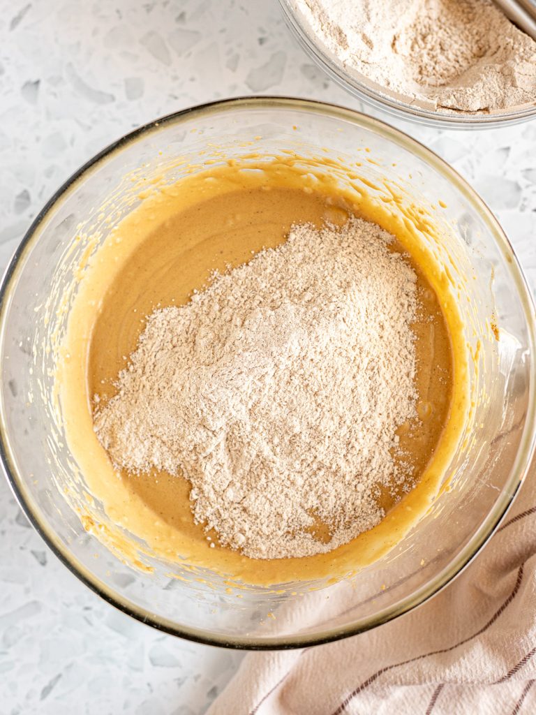 Dry ingredients gradually incorporated into the wet cake batter.