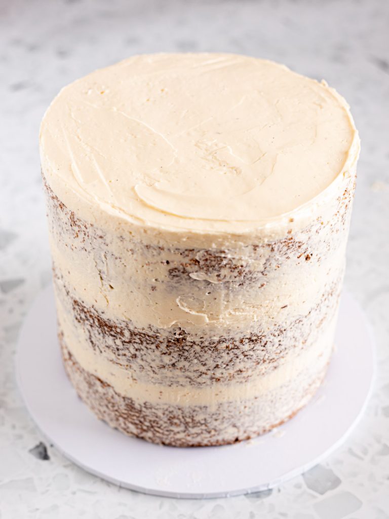 Three-layer vanilla chai cake with a thin coating of Swiss meringue buttercream for a semi-naked finish.
